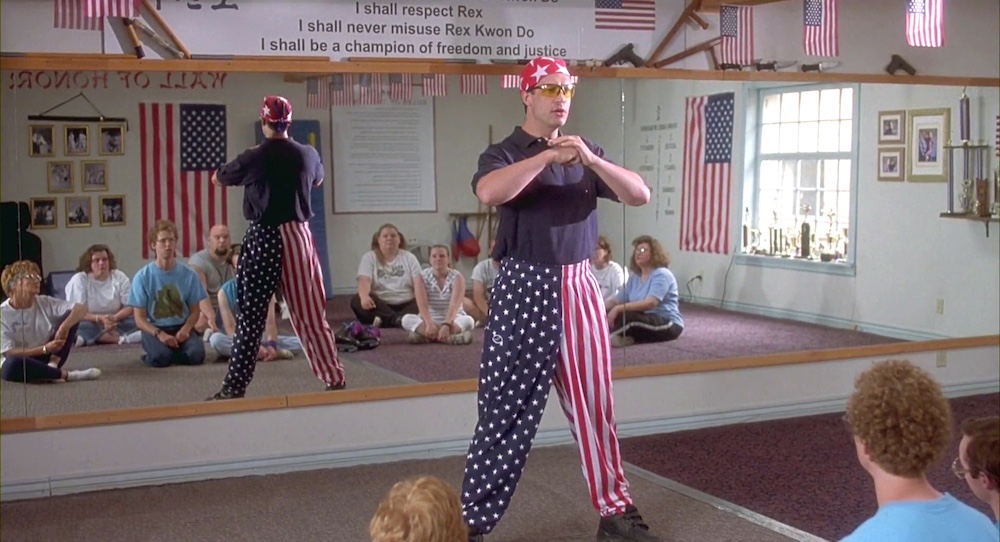Rex standing up in front of his class holding his fist in his hand